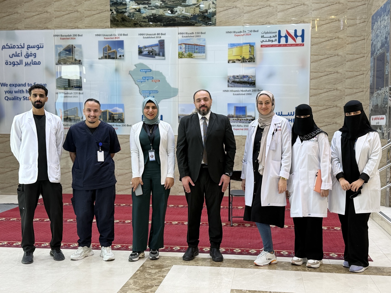 Dr. Mohamed Salama with a multidisciplinary hospital team at Hayat National Hospitals