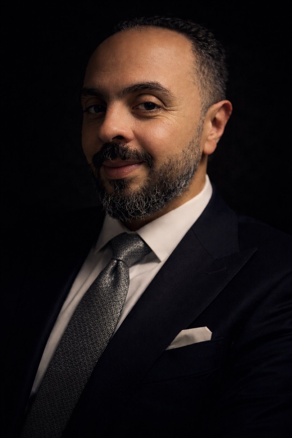 Dr. Mohamed Salama in a formal executive portrait